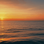 Peaceful ocean skies illuminated by a breathtaking sunset, offering tranquility.