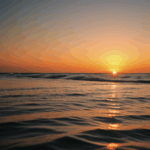 Peaceful sunset over the sea, with vibrant colors illuminating the horizon.