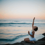 A tranquil yoga session by the sea, emphasizing relaxation and mindfulness in a picturesque coastal environment.