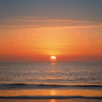 Picturesque ocean sunset with the sky painted in warm, vibrant hues.