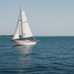 Relaxing sea voyage featuring a classic sailboat, where the gentle waves and tranquil waters unite in harmony.