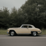 Retro car embarking on a country trip, exemplifying the allure of vintage automobiles and the serenity of rural journeys.