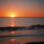 A tranquil ocean sunset with vibrant colors illuminating the horizon.