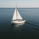 A serene sea voyage with a classic sailboat, offering a harmonious blend of sailing adventure and ocean tranquility.