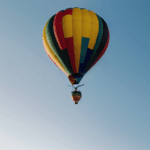 A vibrant hot air balloon exploring the vast sky, inviting adventurers to embark on a thrilling journey.