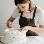 Crafting sugar art designs to embellish a cake with elegance.
