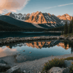 Sunrise over a mountain with a lake reflecting the warm morning hues.