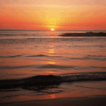 Sunset dreams by the ocean, with vibrant colors reflecting over calm waters.