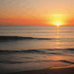 A breathtaking sunset over a calm ocean with vibrant colors in the sky.