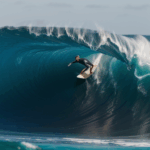 An adventurous surfer capturing the perfect moment on a massive wave, embodying the spirit of surfing.