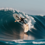 A passionate surfer riding a powerful wave, highlighting their dedication and love for surfing.