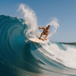 An exciting image of a surfer conquering a big wave, capturing the thrill of the adventure.