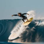 A surfing expert riding a powerful wave, showcasing their mastery and skill in the sport.