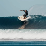 A joyful surfer navigating a massive wave, embodying the excitement and passion for surfing.