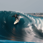 An exhilarating scene of surfing on a massive wave, capturing the essence of thrill and adventure.