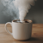 Sweet hot chocolate in a mug, topped with marshmallows and a drizzle of chocolate syrup for a decadent treat.