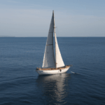 Timeless beauty of a classic sailboat journeying across the tranquil sea, evoking a sense of serenity.