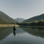 Fishing at a tranquil spot on the lake, surrounded by peaceful landscapes.