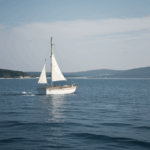 Tranquil waters embrace a classic sailboat, creating a picturesque scene of serenity and timeless sailing charm.