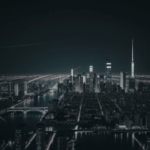 The urban landscape at night, highlighting the contrast between modern structures and the serene night sky.
