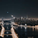 An expansive urban nightscape featuring vibrant city lights and architecture.