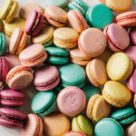 A delightful assortment of colorful macarons in various bright shades, perfect for dessert enthusiasts.