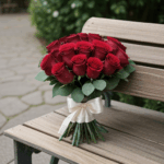 Romantic floral display of roses on a wooden bench, creating a serene setting.