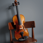 A violin placed on a wooden chair, evoking the timeless allure of music.