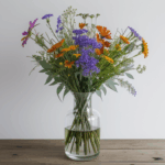 A vibrant bouquet of assorted wildflowers beautifully arranged in a clear glass vase, showcasing the natural beauty of each bloom.
